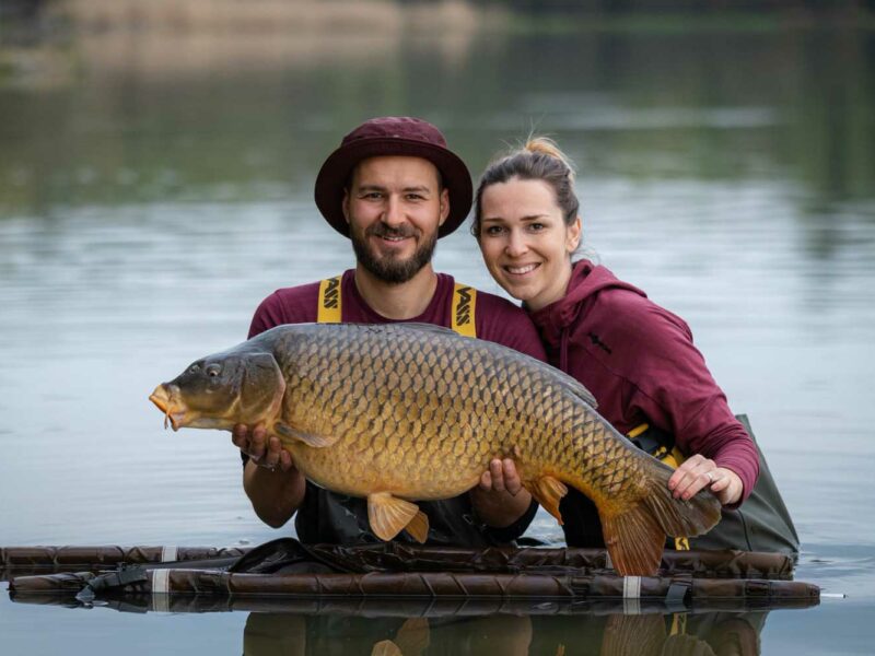 Zwei Karpfenangler mit großem Karpfen am Wasser bei Katlov Lakes